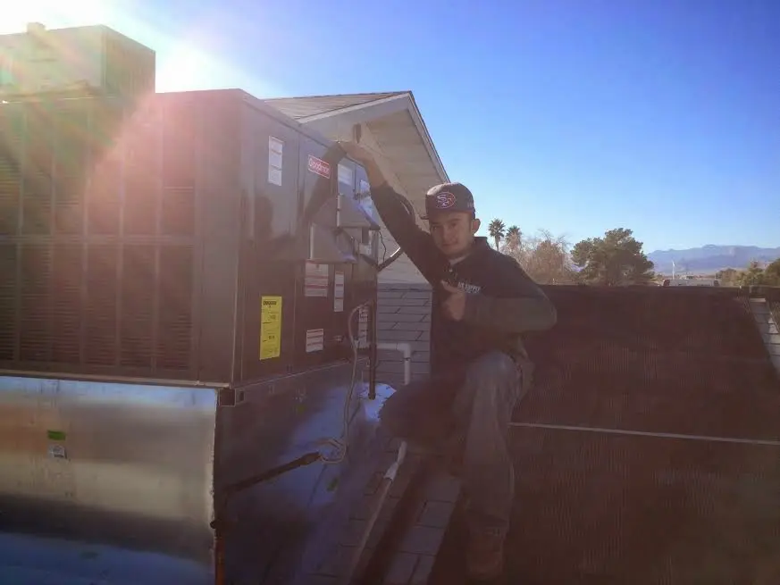 HVAC technician performing Air Duct Cleaning on a rooftop unit in Havelock